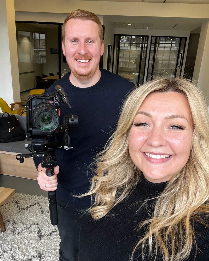 Sam on set with a camera