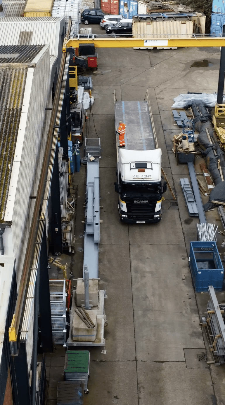 Aerial of the Apex Steel yard, the branded gantry crane loading long steelwork onto a lorry