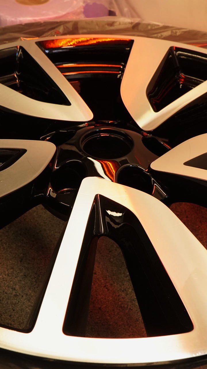 A freshly sprayed gloss black and diamond cut wheel