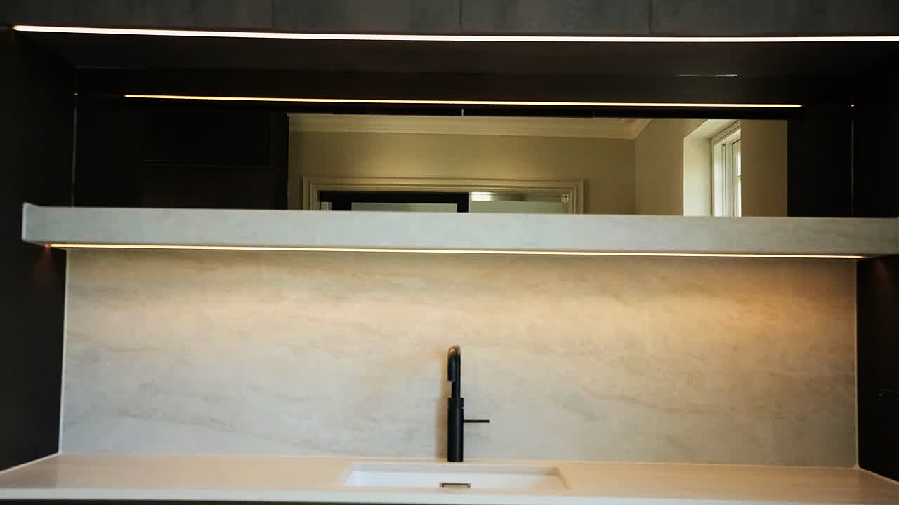 A lit stone shelf and tap, from the August two camera shoot