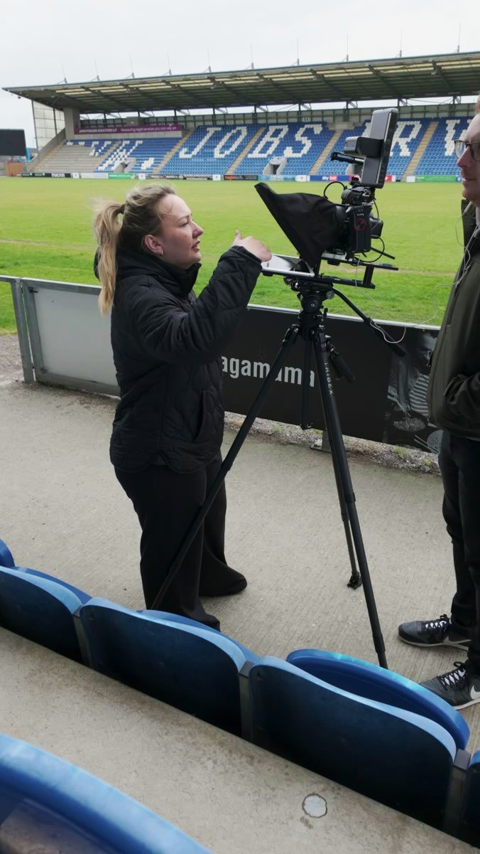 The camera and teleprompter set up at a stadium