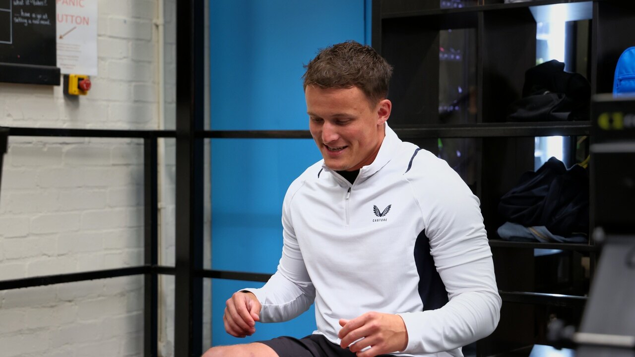 A coach laughing between sets