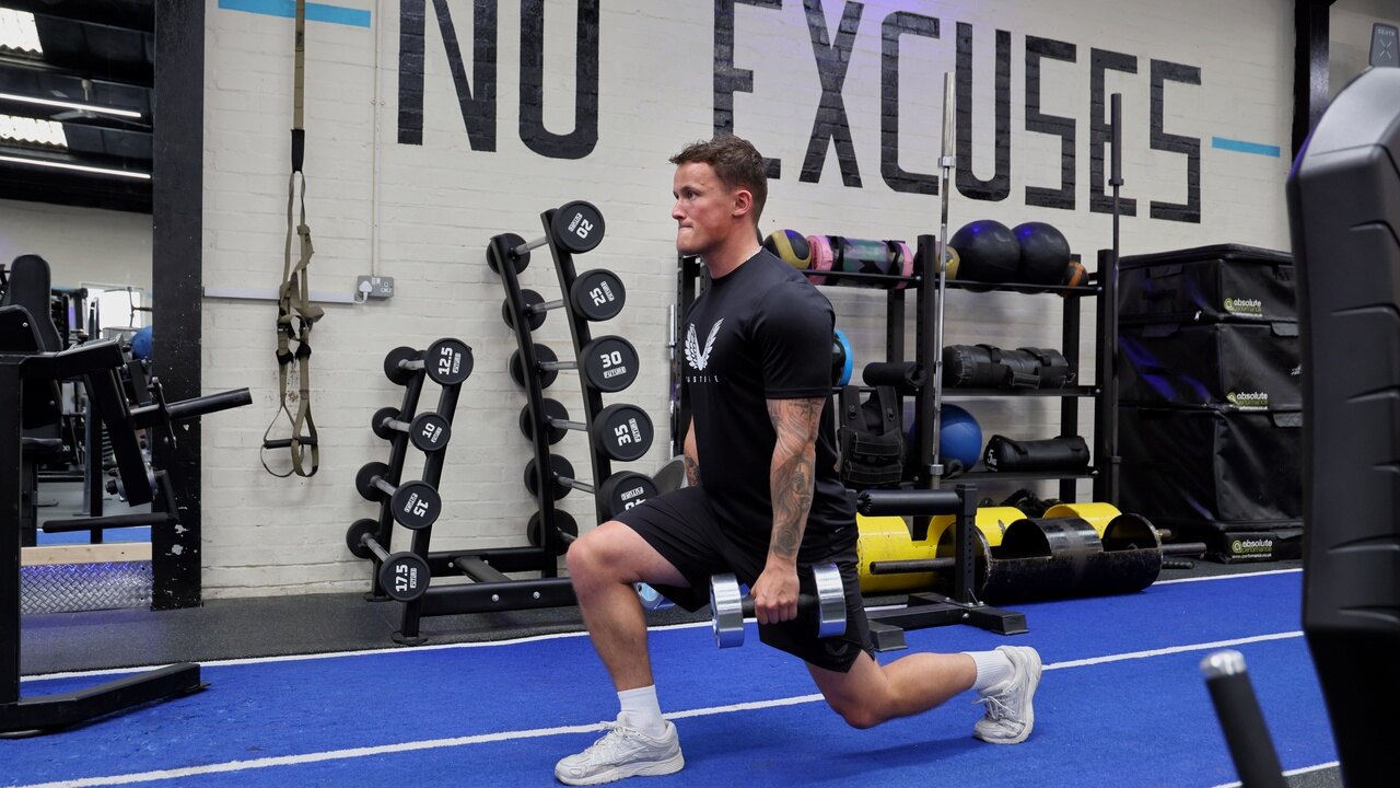 A lunge on the blue track in front of the No Excuses wall