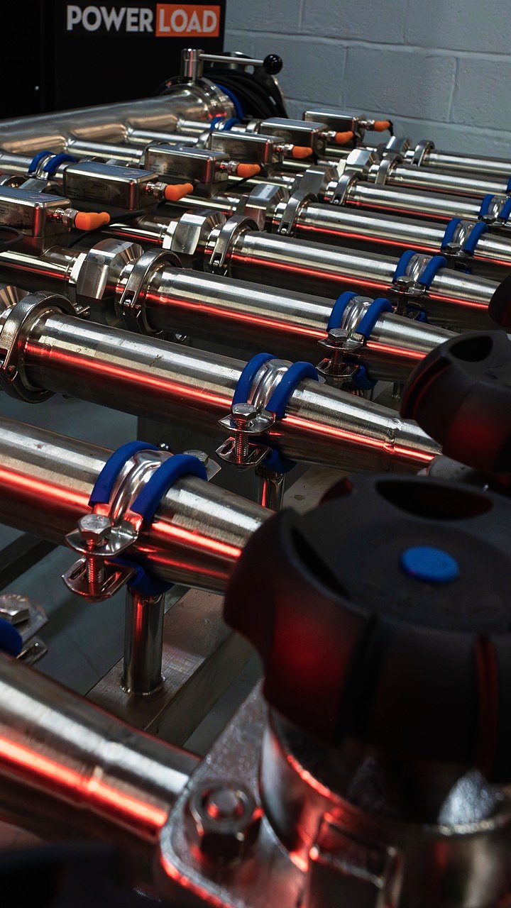 A stainless manifold and valve handles, close up