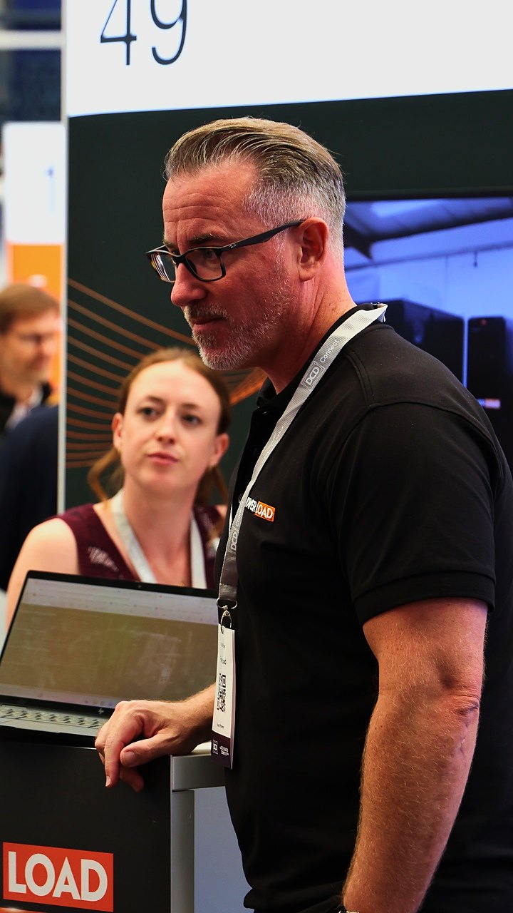 Russell Parker talking to visitors at PowerLoad stand 49