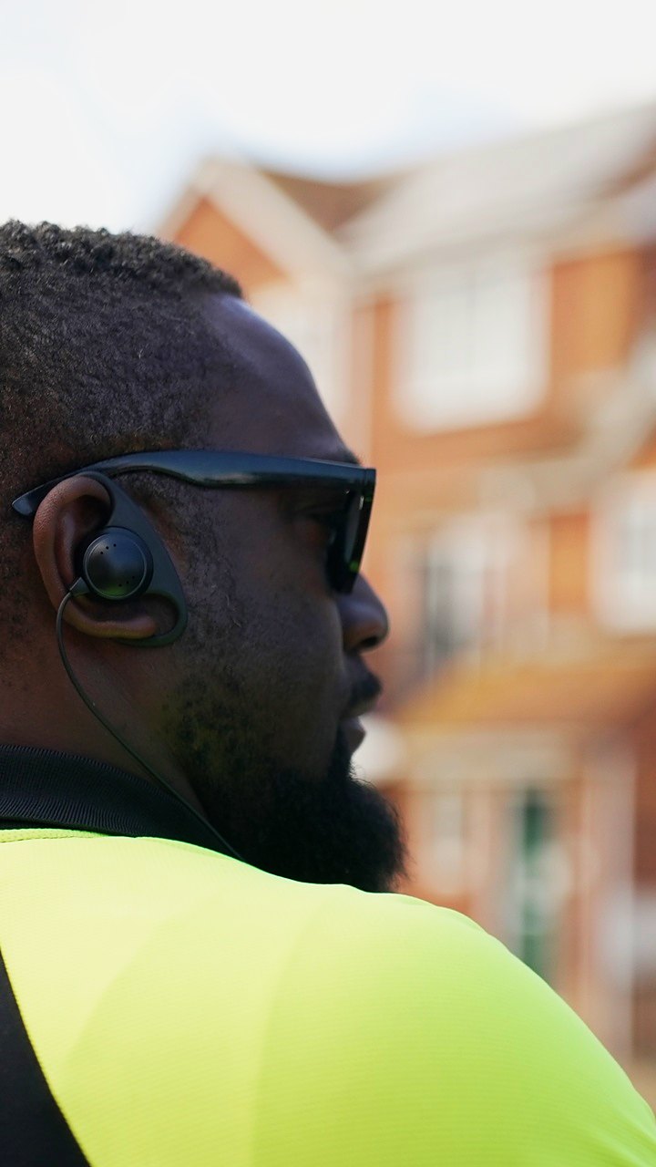 A Regency Security officer in profile, listening on his earpiece at Clacton Airshow