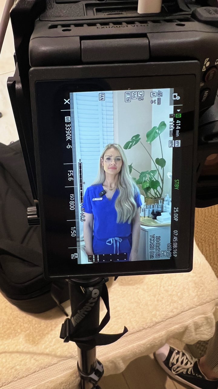 Sasha on the camera monitor during a content day at her clinic