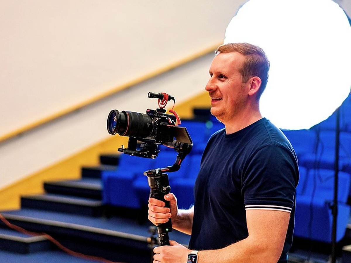 Sam shooting on a gimbal with a shotgun mic in a theatre venue
