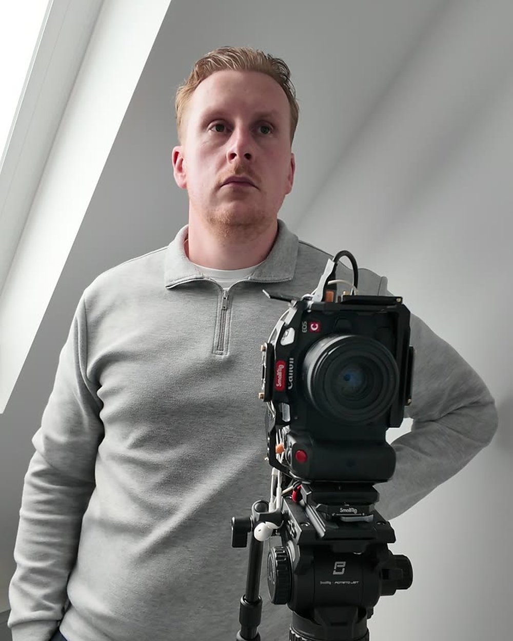 A member of our crew beside a cinema camera on a tripod, set up in a dental surgery