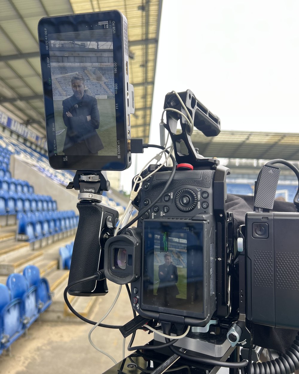 Cinema camera with a portrait monitor showing a seated solicitor framed for an interview