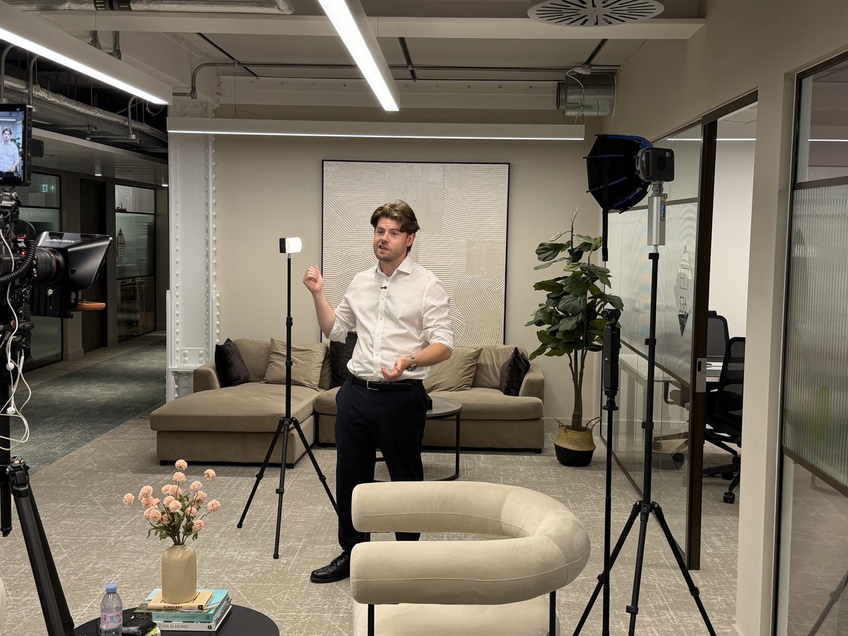 Interviewee talking to camera in a lit lounge set, the kind of setup used for a team Christmas message