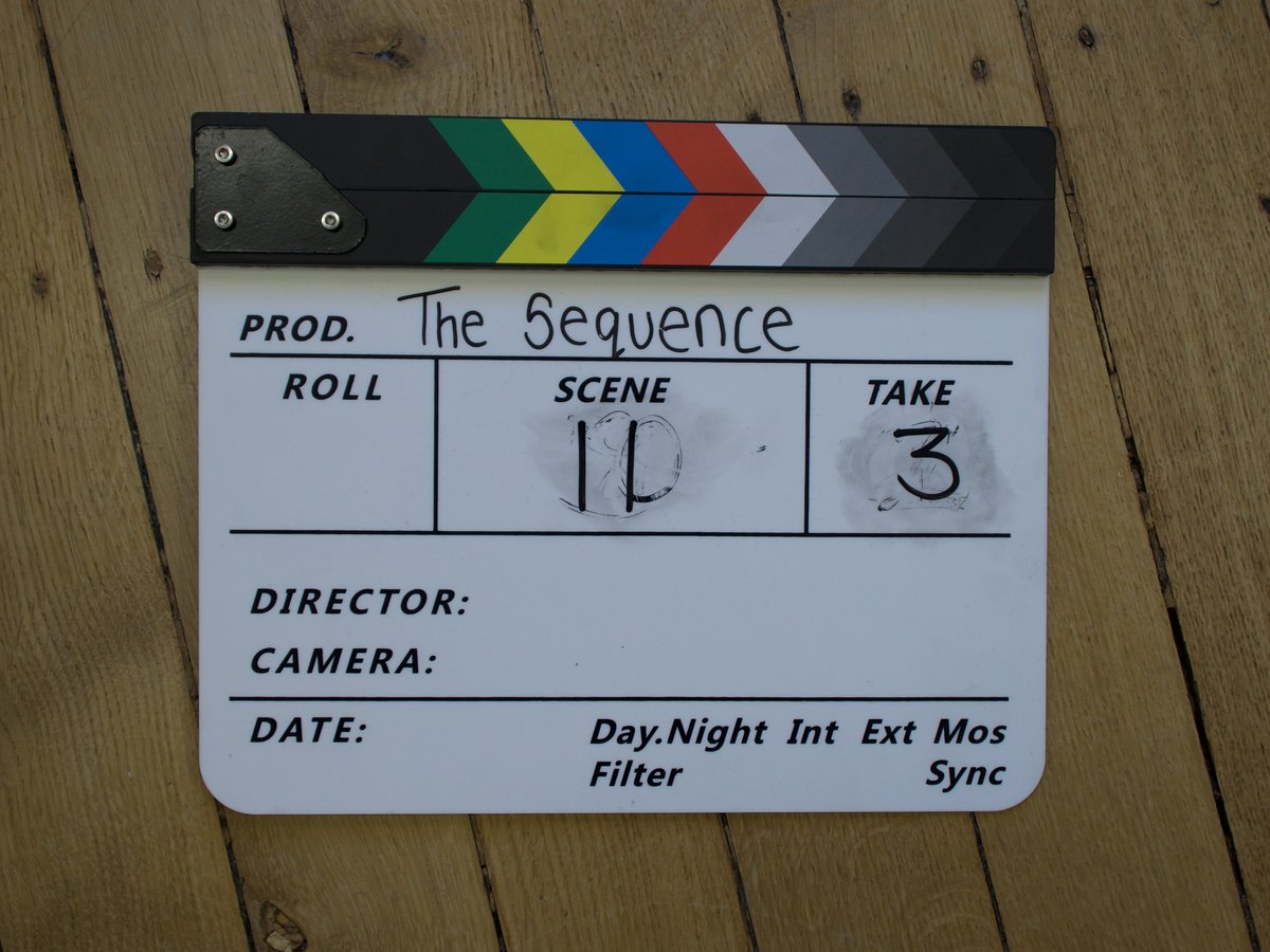 A clapperboard on a wooden floor, ready for the next take