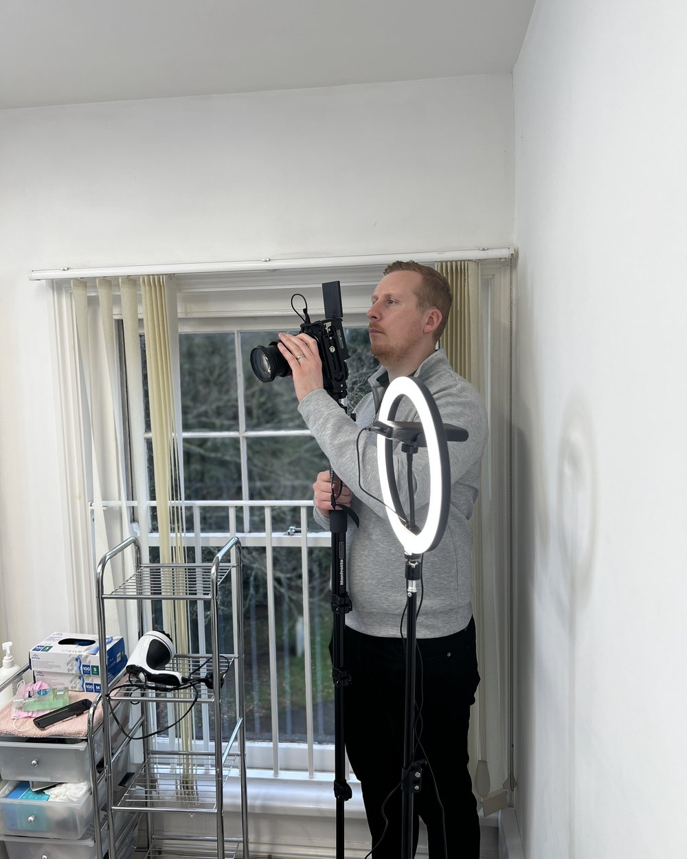 Sam shooting video with a camera rig and ring light in a clinic treatment room