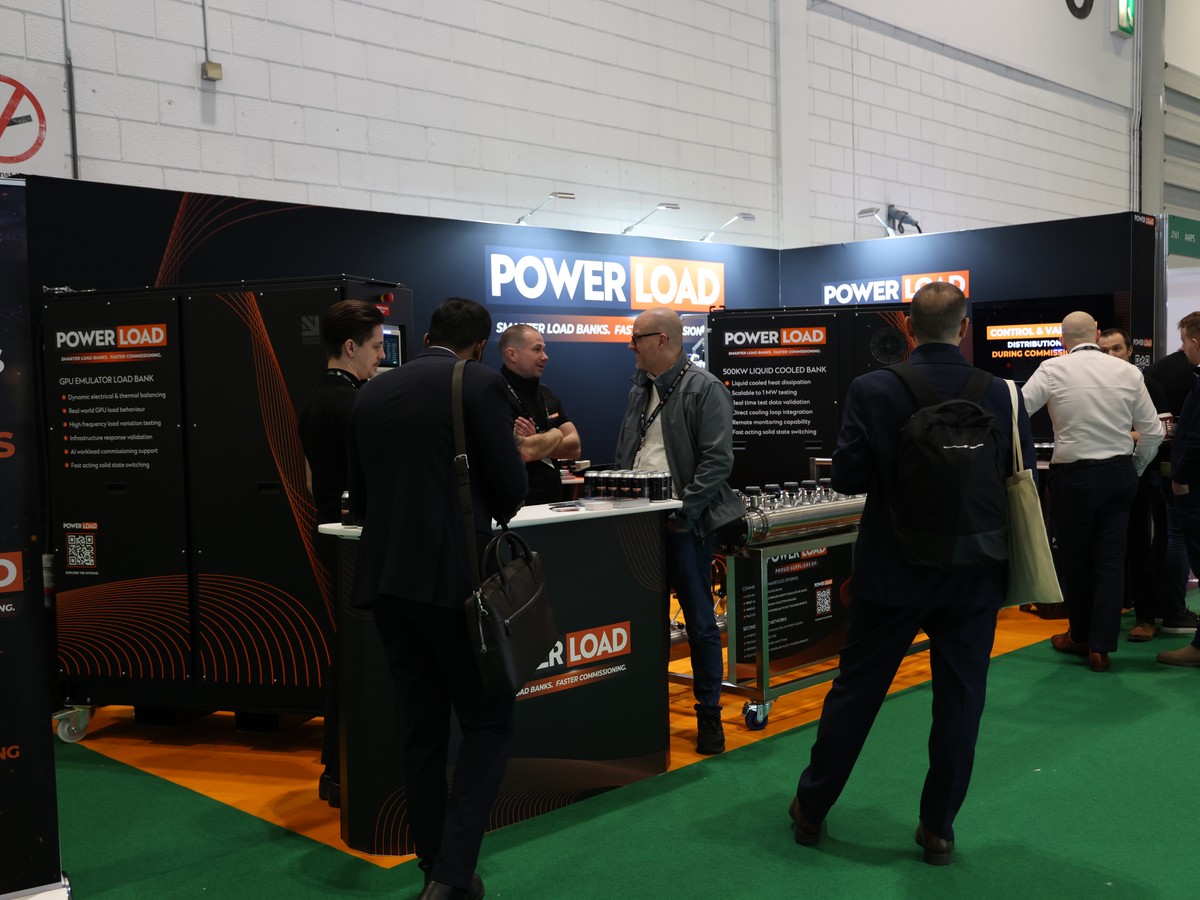 The PowerLoad stand at Data Centre World, ExCeL London, with visitors at the counter
